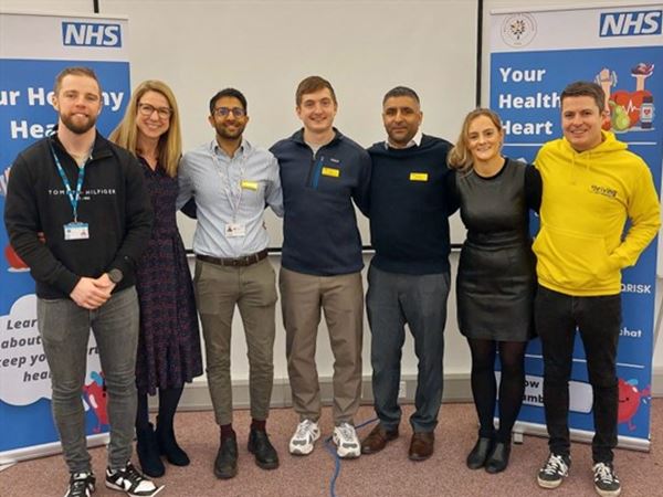 Photo shows staff at Your Healthy Heart event smiling